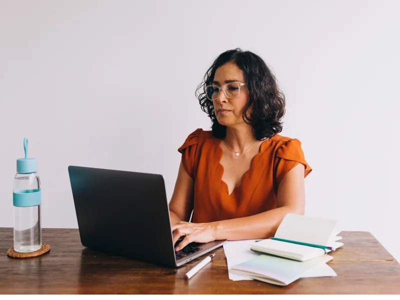 An advisor building lesson plans on a laptop